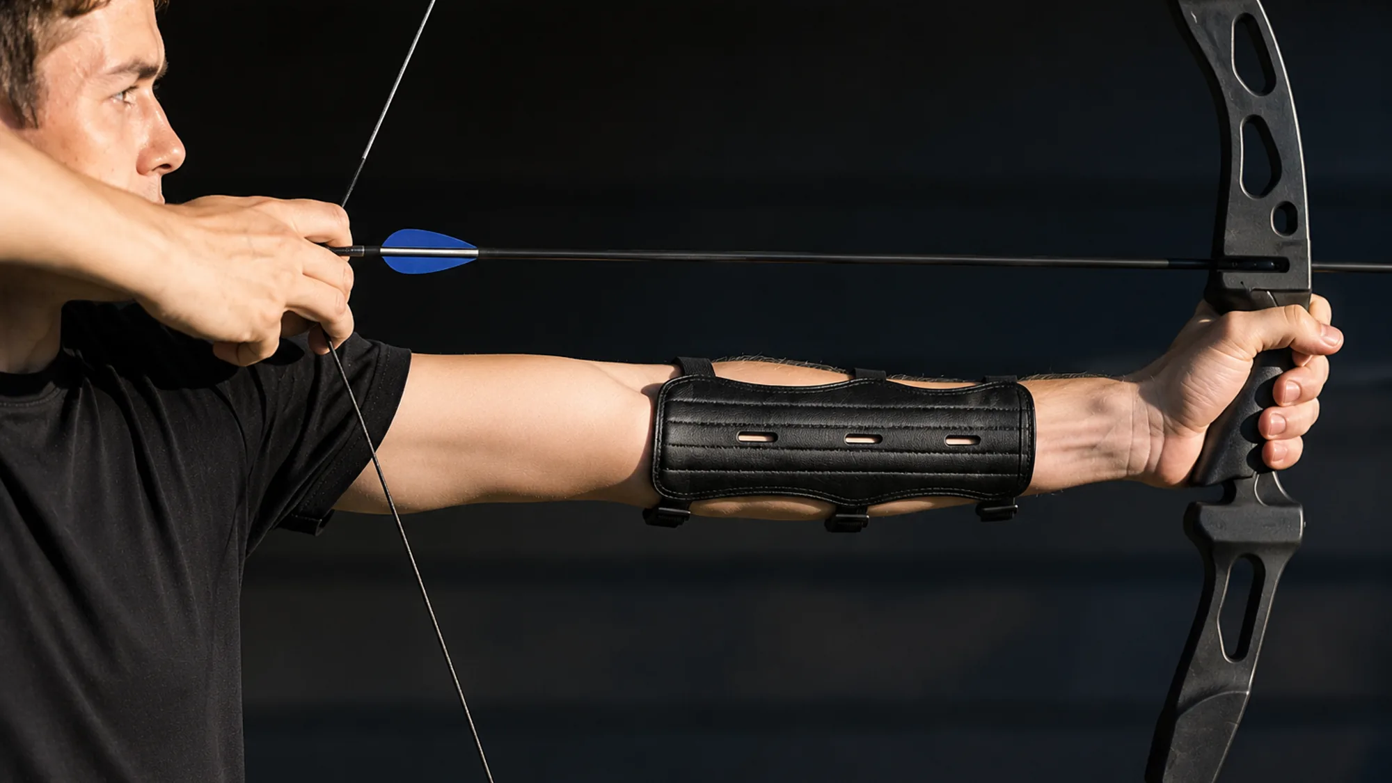 Side view at full draw showing the string running clear of the inner forearm protected by the arm guard